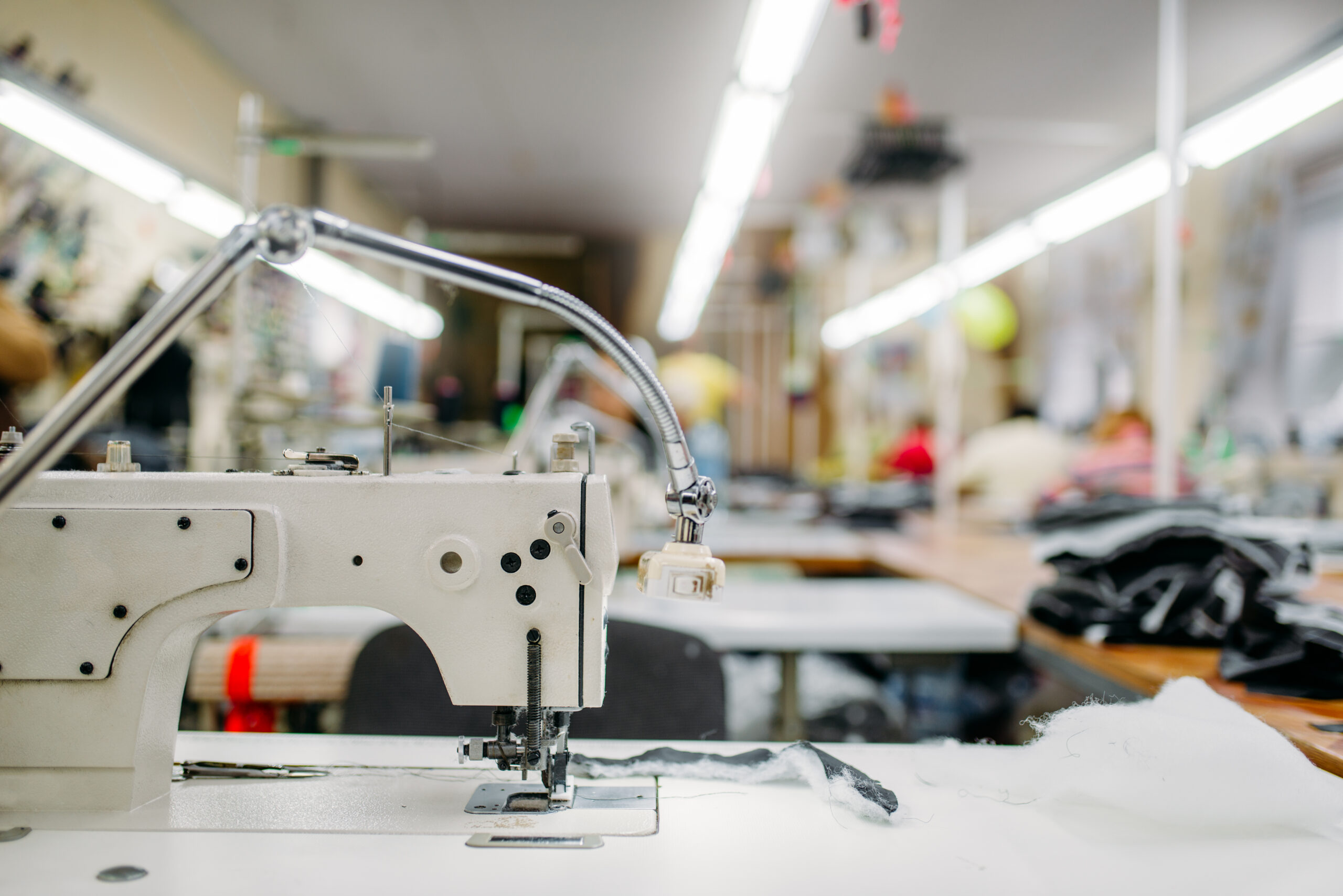 Sewing machine on clothing fabric, nobody. Dressmaking industry, Equipment on dress factory, professional tailoring